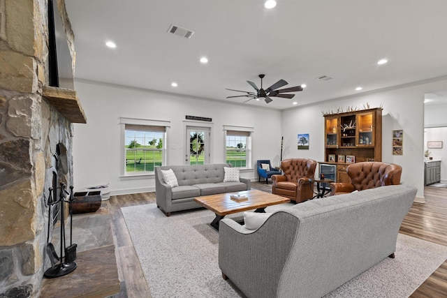 275 Ed Dutton Rd, Pottsboro, TX 75076 - living room featuring a stone fireplace, a ceiling fan, recessed lighting, dark wood finished floors, and baseboards
