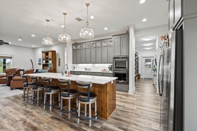 275 Ed Dutton Rd, Pottsboro, TX 75076 - kitchen with stainless steel appliances, open floor plan, gray cabinetry, light countertops, and a sink