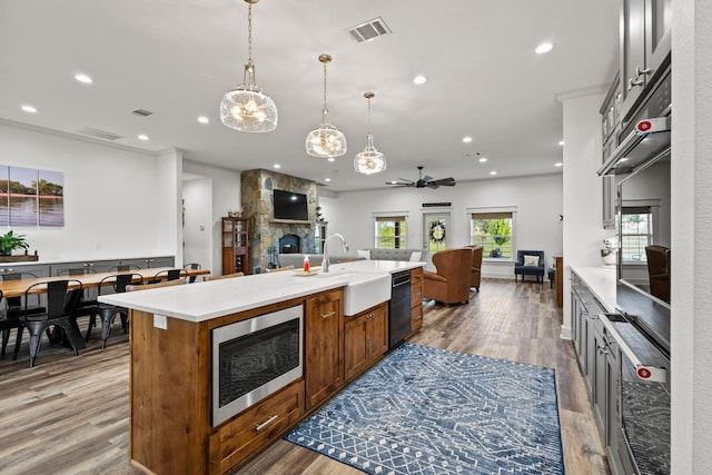 275 Ed Dutton Rd, Pottsboro, TX 75076 - kitchen featuring a sink, open floor plan, stainless steel microwave, dishwasher, and a stone fireplace