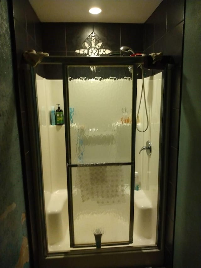 bathroom featuring recessed lighting and a shower stall