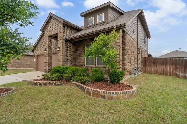 view of front facade with brick siding, fence, driveway, and a front yard