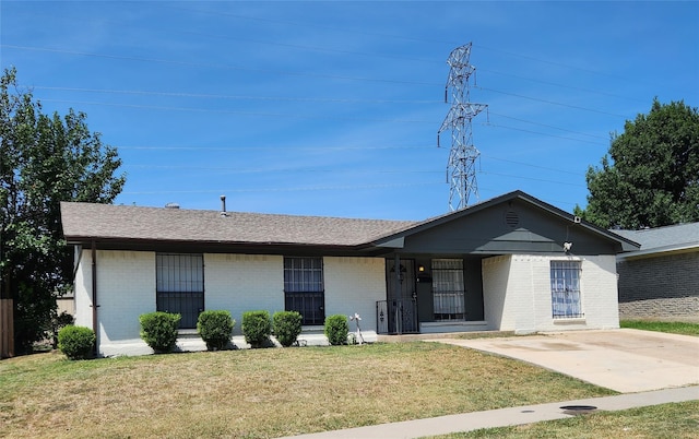 single story home with roof with shingles, a front lawn, and brick siding