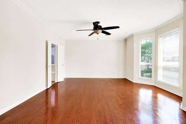 spare room featuring crown molding, a ceiling fan, baseboards, and wood finished floors