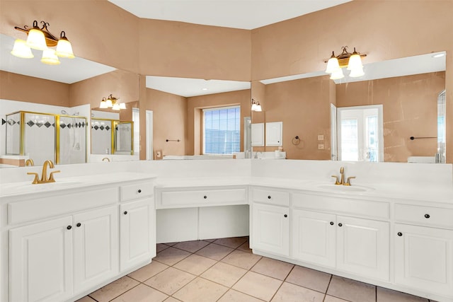 bathroom with a shower stall, tile patterned flooring, and vanity