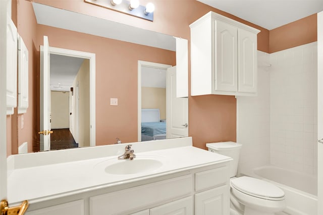 ensuite bathroom with vanity, toilet, shower / tub combination, and connected bathroom