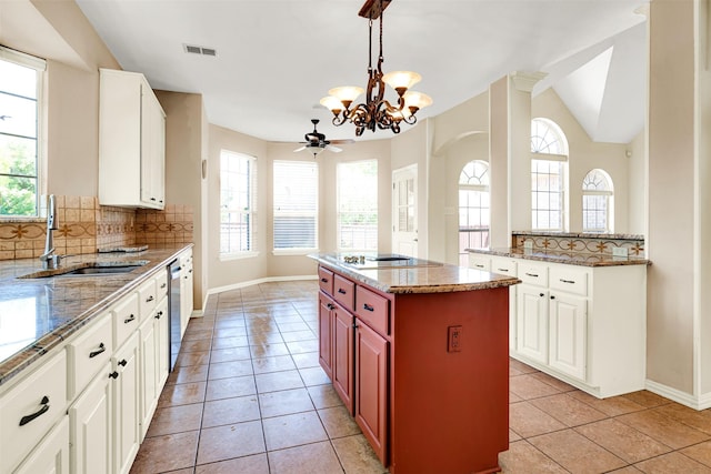3837 Evesham Dr, Plano, TX 75025 - kitchen featuring a sink, black electric cooktop, healthy amount of natural light, baseboards, and vaulted ceiling