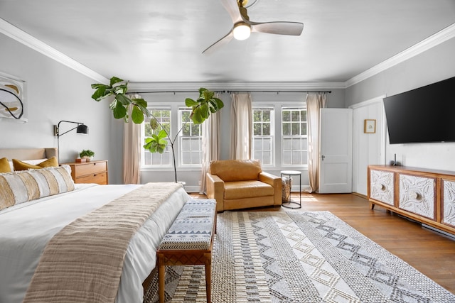 bedroom with crown molding, ceiling fan, and wood finished floors