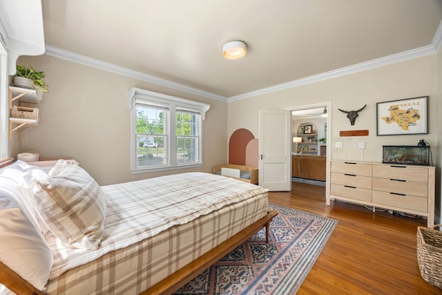 bedroom featuring ornamental molding and dark wood-type flooring