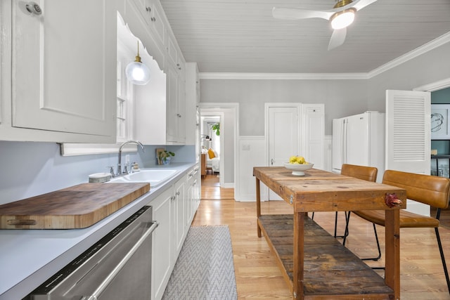 kitchen with freestanding refrigerator, light wood-type flooring, white cabinets, a sink, and dishwasher