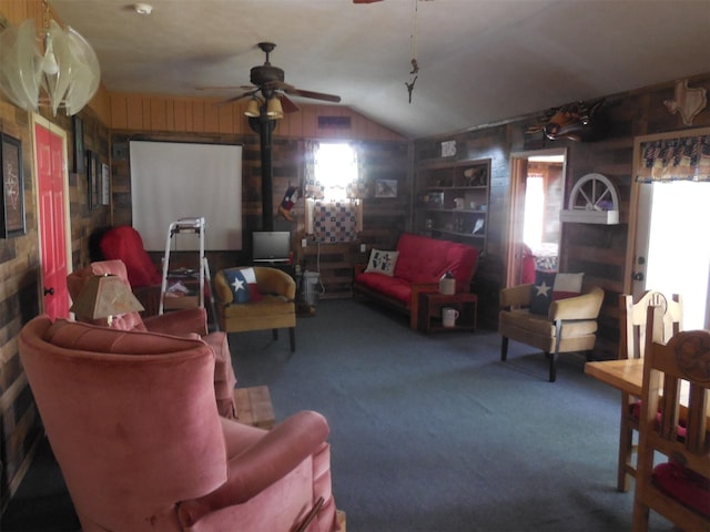 126 County Road 541, Eastland, TX 76448 - carpeted living room with a ceiling fan, wood walls, vaulted ceiling, and a healthy amount of sunlight