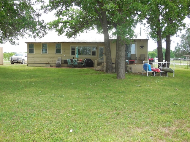 126 County Road 541, Eastland, TX 76448 - back of house with a lawn and fence