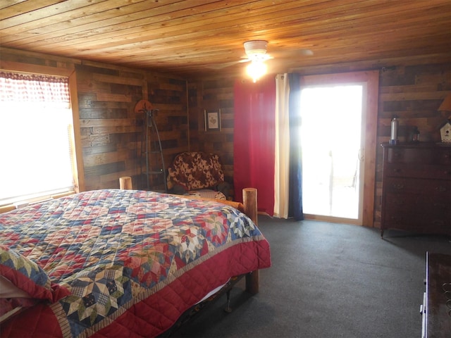 126 County Road 541, Eastland, TX 76448 - carpeted bedroom featuring wooden walls, wood ceiling, and multiple windows