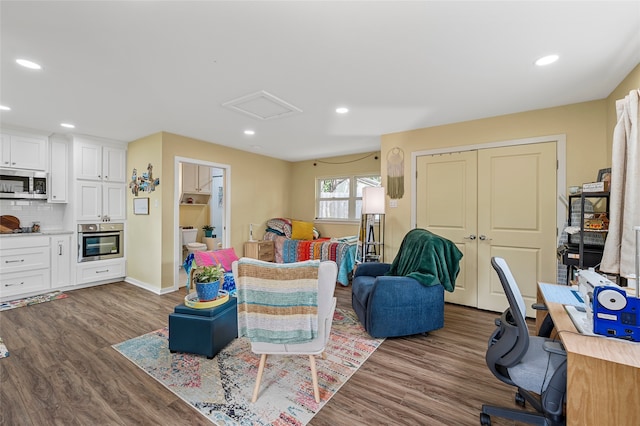 living area featuring recessed lighting, attic access, dark wood finished floors, and baseboards