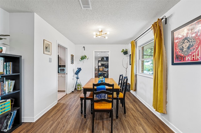 dining room with visible vents, dark wood-style flooring, and baseboards