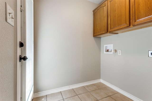 clothes washing area with cabinet space, washer hookup, baseboards, electric dryer hookup, and light tile patterned floors