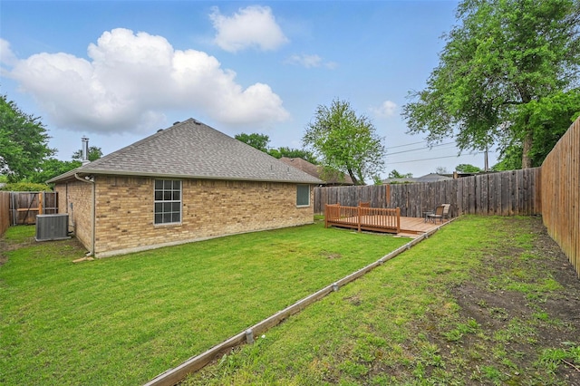 view of yard featuring a fenced backyard, a wooden deck, and central AC unit