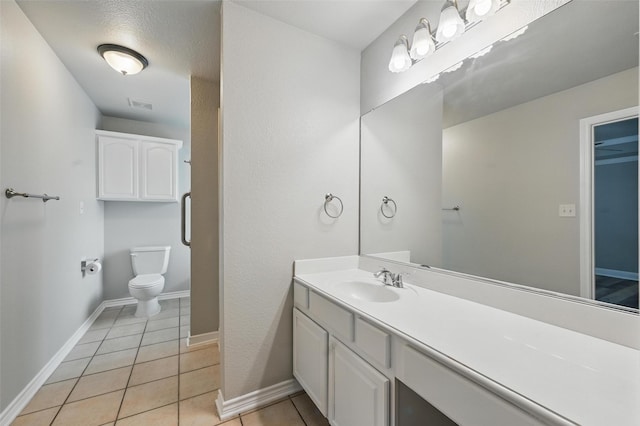 bathroom with toilet, tile patterned floors, visible vents, and vanity