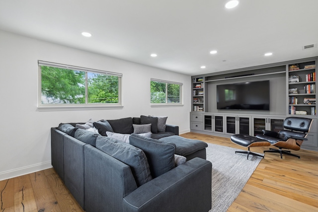 living area featuring recessed lighting, baseboards, and visible vents