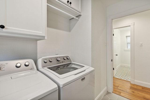 9918 Rustleleaf Dr, Dallas, TX 75238 - laundry area featuring washing machine and dryer, baseboards, and cabinet space