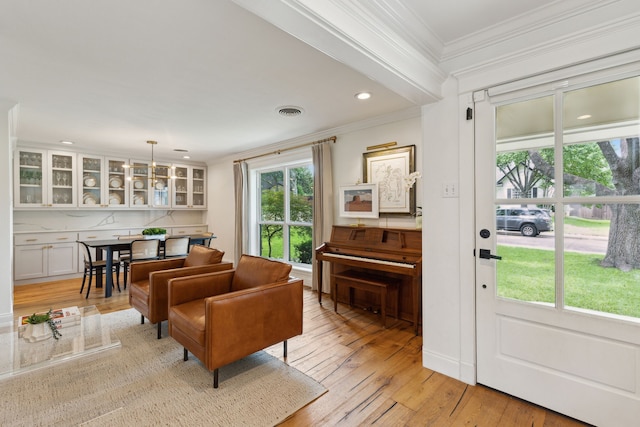 9918 Rustleleaf Dr, Dallas, TX 75238 - living room featuring crown molding, light wood finished floors, and recessed lighting