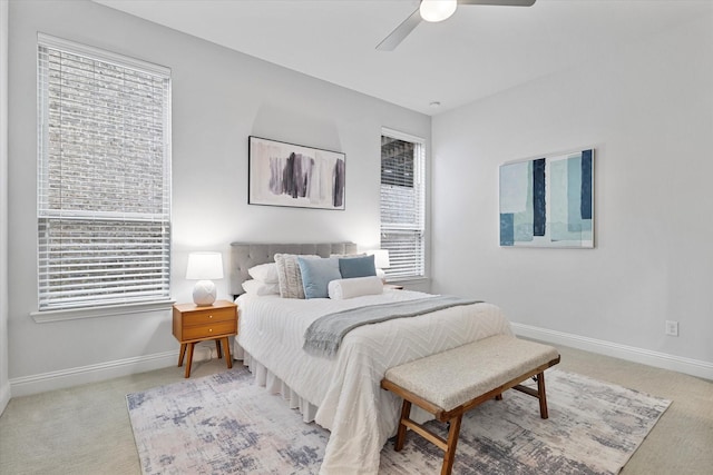 bedroom featuring carpet flooring, multiple windows, and baseboards