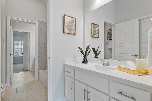 full bathroom with vanity, tile patterned floors, toilet, and baseboards