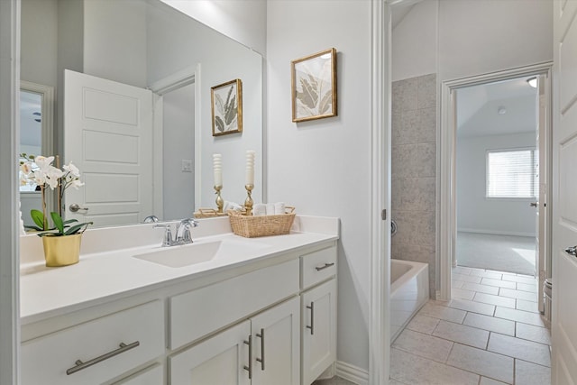 bathroom featuring vanity, tile patterned floors, baseboards, and washtub / shower combination