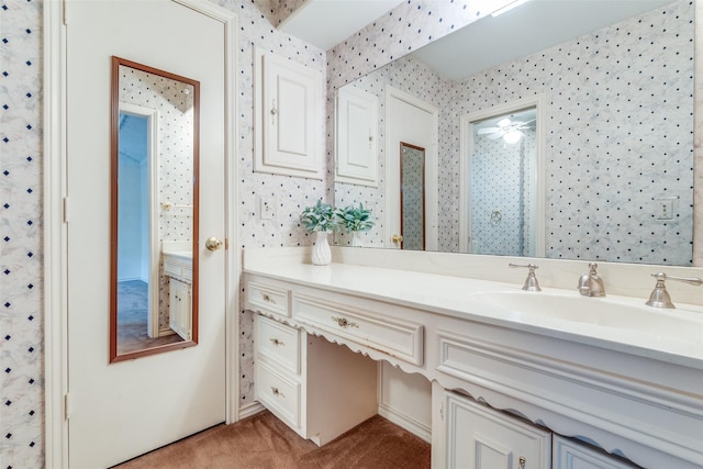 bathroom featuring a ceiling fan, wallpapered walls, and vanity