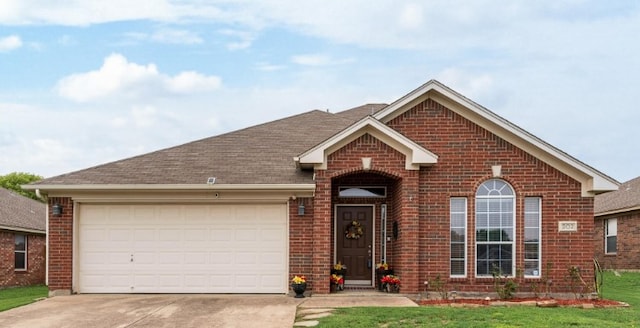 single story home featuring brick siding, a garage, roof with shingles, and driveway