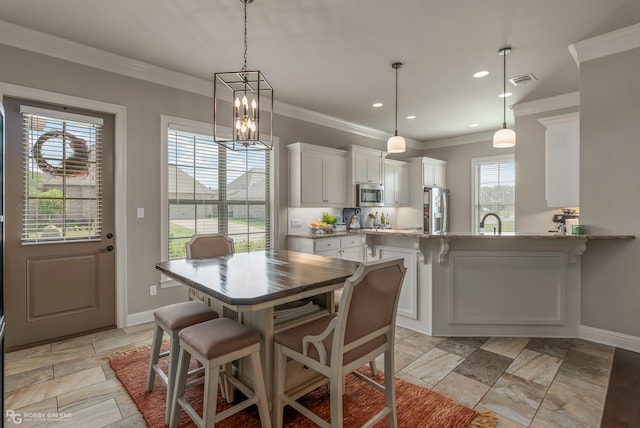 1113 Cypress Creek Cir, Shreveport, LA 71106 - dining area with stone tile floors, ornamental molding, baseboards, recessed lighting, and a chandelier