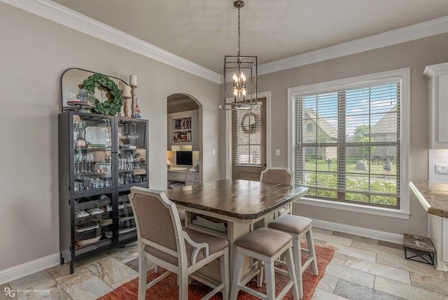 1113 Cypress Creek Cir, Shreveport, LA 71106 - dining room with crown molding, arched walkways, baseboards, and a notable chandelier