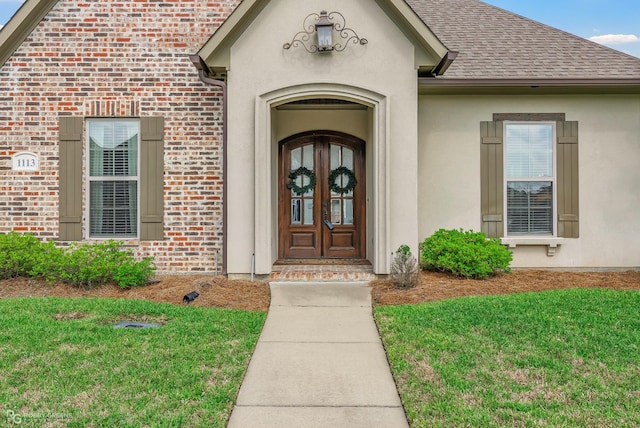 1113 Cypress Creek Cir, Shreveport, LA 71106 - property entrance with a lawn, brick siding, roof with shingles, and stucco siding