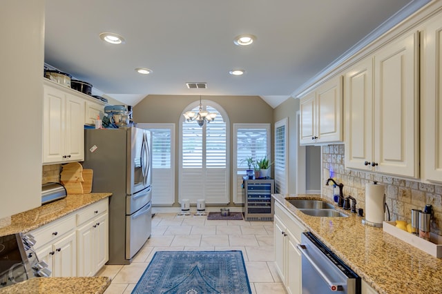 3666 Crestview Dr, Shreveport, LA 71119 - kitchen with backsplash, appliances with stainless steel finishes, a sink, and lofted ceiling