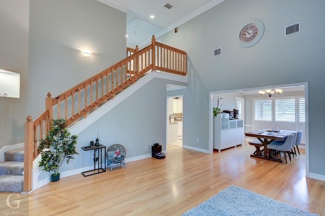 3666 Crestview Dr, Shreveport, LA 71119 - interior space with visible vents, an inviting chandelier, a towering ceiling, wood finished floors, and baseboards