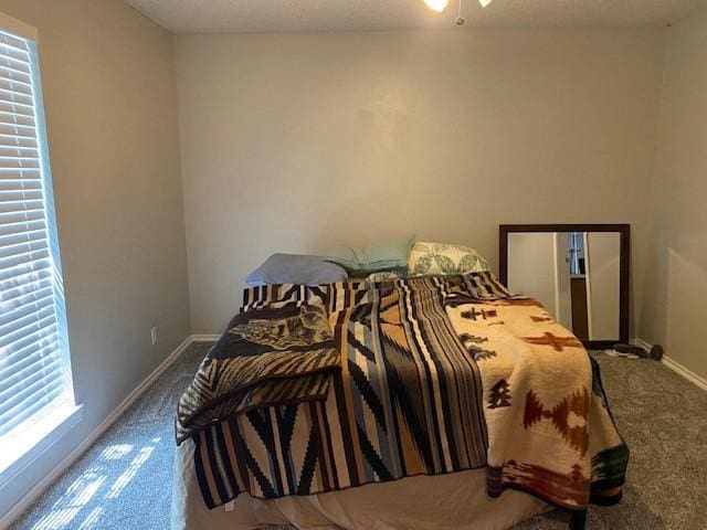 carpeted bedroom featuring baseboards