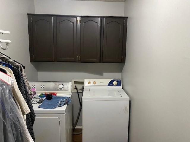 washroom with washer and dryer and cabinet space