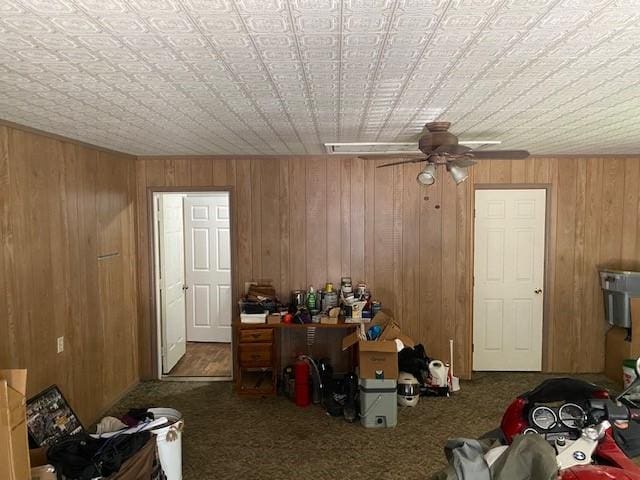 unfurnished bedroom featuring carpet flooring and wood walls
