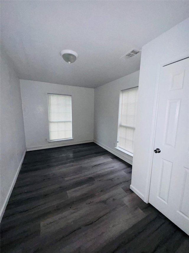 7539 Red Bud Dr, Dallas, TX 75227 - unfurnished room with baseboards, visible vents, and dark wood-style floors