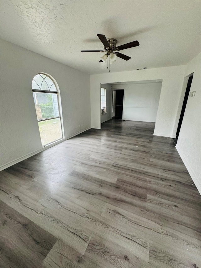 7539 Red Bud Dr, Dallas, TX 75227 - unfurnished room with ceiling fan, a textured ceiling, plenty of natural light, and wood finished floors
