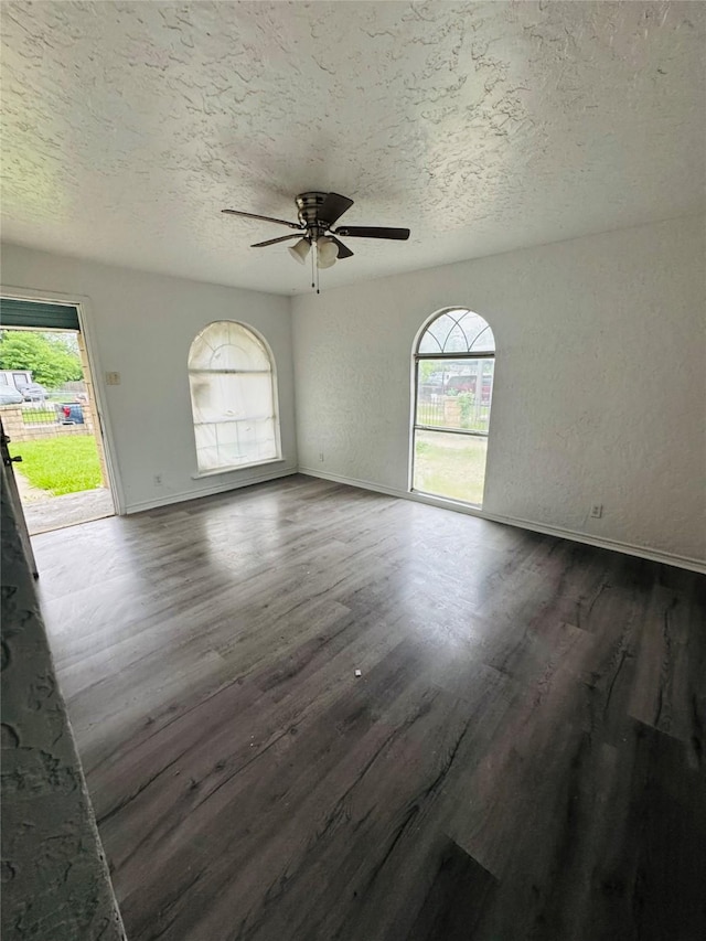 7539 Red Bud Dr, Dallas, TX 75227 - interior space featuring baseboards, dark wood-style flooring, a textured ceiling, and ceiling fan