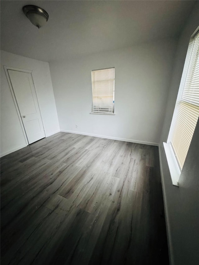 7539 Red Bud Dr, Dallas, TX 75227 - unfurnished bedroom featuring baseboards and dark wood-style floors