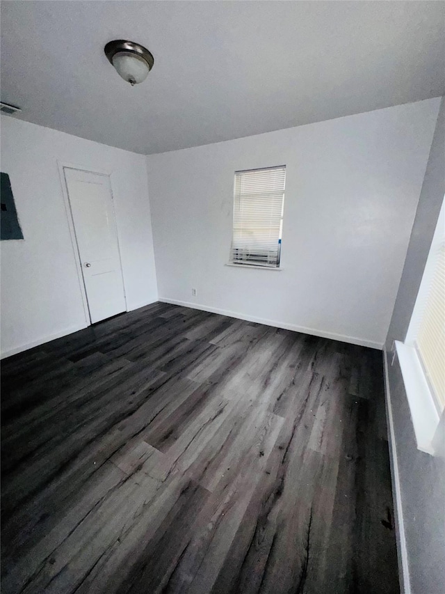7539 Red Bud Dr, Dallas, TX 75227 - empty room featuring baseboards, a healthy amount of sunlight, and dark wood-type flooring