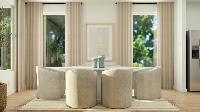 dining room with baseboards and light wood-type flooring