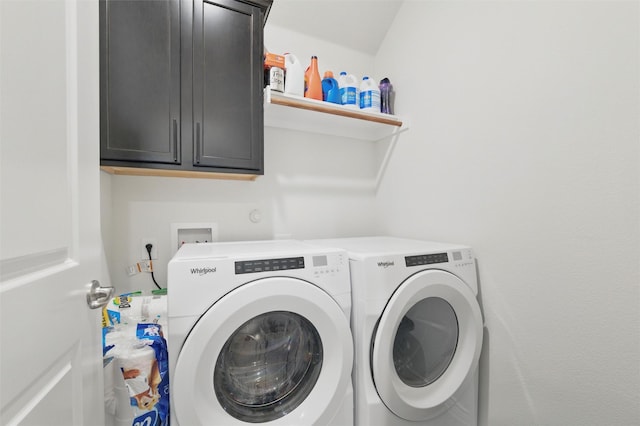 laundry room featuring separate washer and dryer and cabinet space