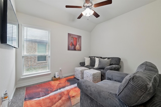 living area featuring baseboards, carpet flooring, ceiling fan, and lofted ceiling