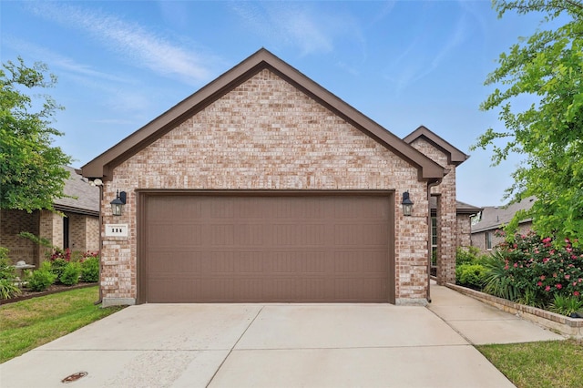 view of front of home with concrete driveway, brick siding, and a garage
