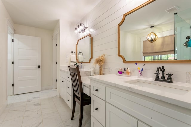 bathroom featuring vanity, marble finish floor, wooden walls, and visible vents