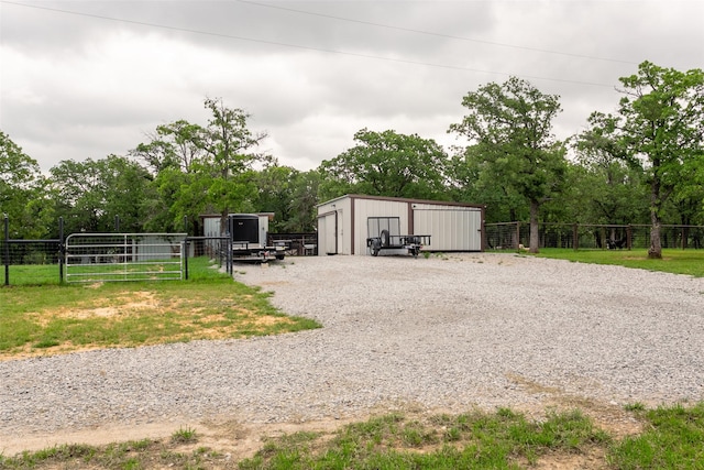 view of pole building with fence and a gate