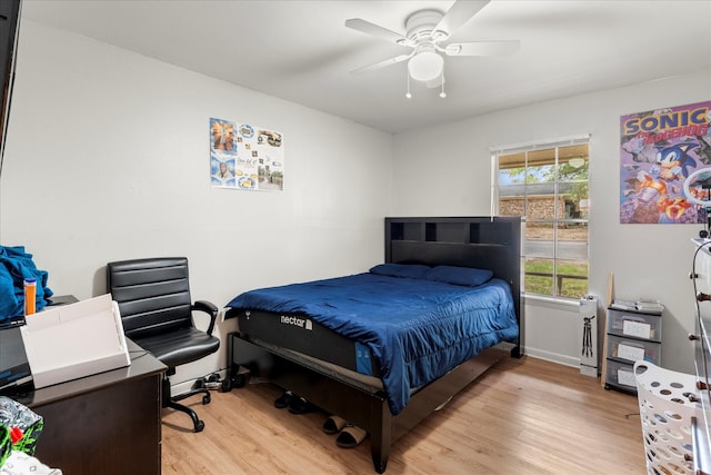 bedroom with a ceiling fan, baseboards, and light wood-type flooring