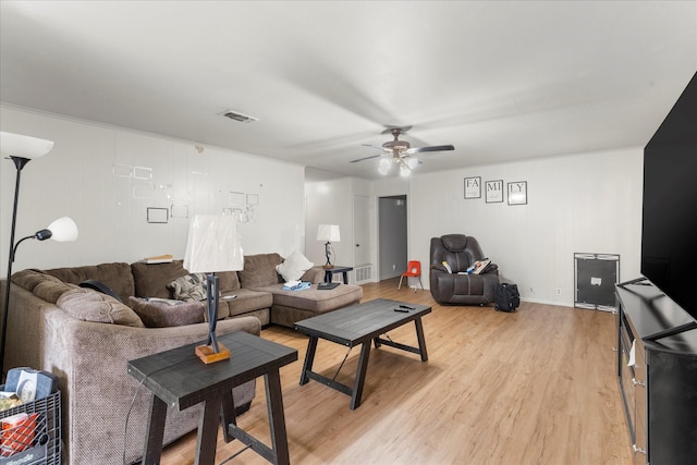 living area with light wood-style floors, ceiling fan, and visible vents
